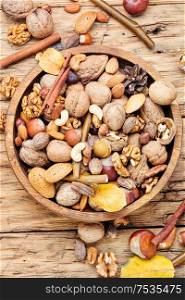 Nuts mix in a wooden plate.Different types of nuts.. Assortment of nuts