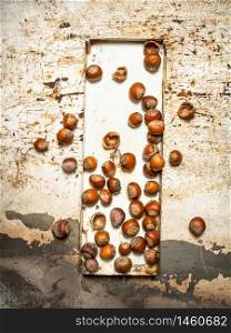 Nuts on the old tray. On rustic background.. Nuts on the old tray.