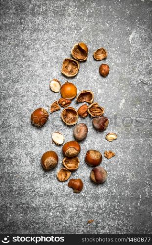 Nuts with shells. On the stone table.. Nuts with shells.