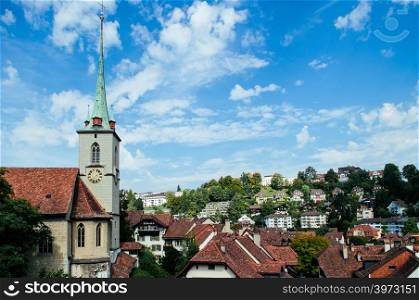 Nydeggkirche 14th century Protestant church with bronze reliefs and clock tower next to Untertorbrucke bridge old town Bern - Switzerland