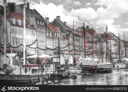 Nyhavn is the old harbor of Copenhagen. Denmark. black and red and white photo
