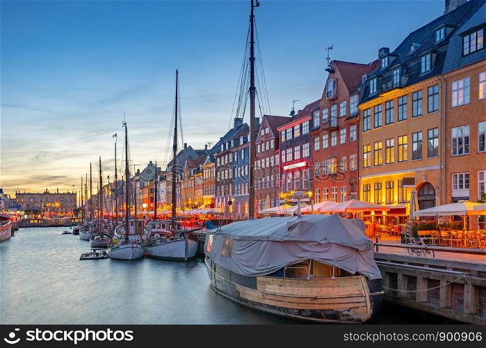 Nyhavn landmark buildings at night in Copenhagen city, Denmark.