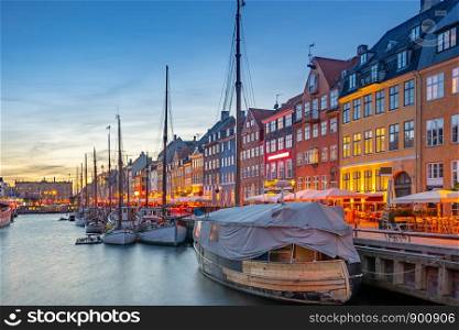 Nyhavn landmark buildings at night in Copenhagen city, Denmark.