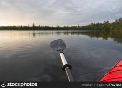 Oar extended over the water, Lake of The Woods, Ontario, Canada