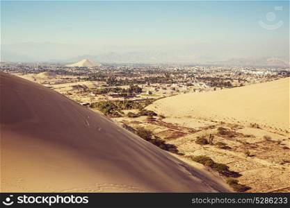 Oasis in desert sand dunes near the city of Ica, Peru