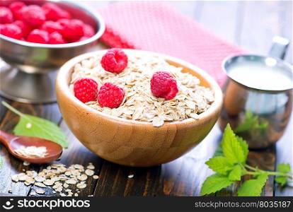oat flakes in bowl and on a table