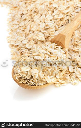 oat flakes in spoon isolated on white background
