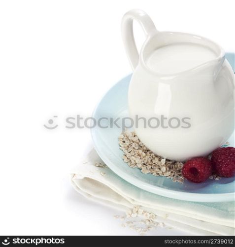 Oat flakes, milk and berries over white