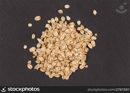 oat flakes on a dark stone board