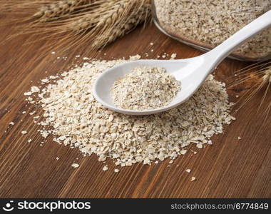 Oat flakes. Selective focus. on wooden table