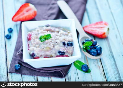 oat flakes with fruit in bowl on a table