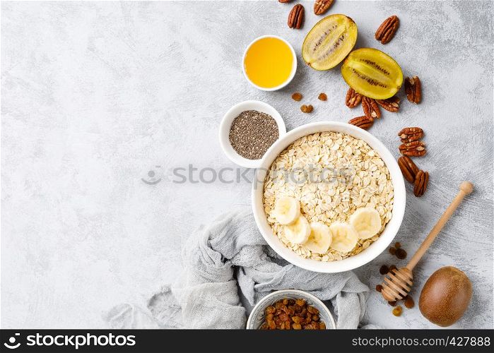 Oat flakes with fruits, nuts and honey in bowl