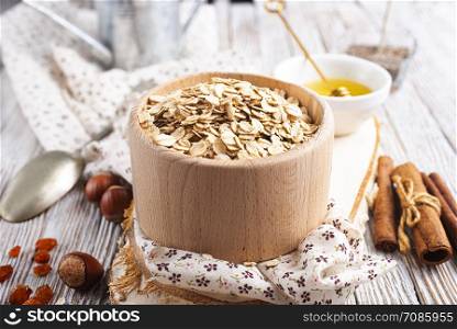 oat flakes with nuts and raisin, oat flakes in wooden bowl