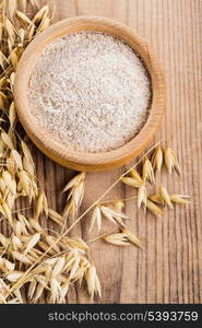 Oat meal in bowl on the wooden table