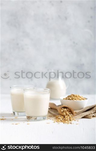 Oat milk. Healthy vegan non-dairy organic drink with flakes