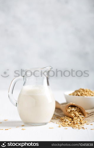 Oat milk. Healthy vegan non-dairy organic drink with flakes