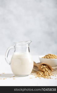 Oat milk. Healthy vegan non-dairy organic drink with flakes