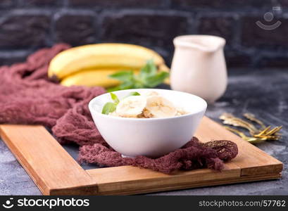 oat porridge with fresh banana in the bowl