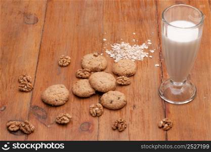 Oatmeal cookies and glass of milk on wooden old boards. oatmeal cookies on a wooden table