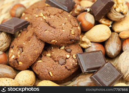 oatmeal cookies, chocolate and nuts on a wicker mat