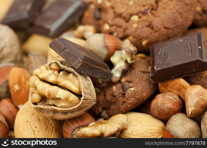 oatmeal cookies, chocolate and nuts on a wicker mat