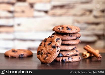 Oatmeal cookies with chocolate and cinnamon on a wooden table. Oatmeal cookies with chocolate and cinnamon
