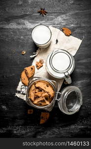 Oatmeal cookies with fresh milk. On a black wooden background.. Oatmeal cookies with fresh milk.