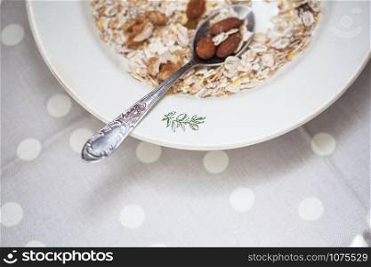 Oatmeal in bowl with nuts, useful food. Oatmeal bowl with nuts, useful food