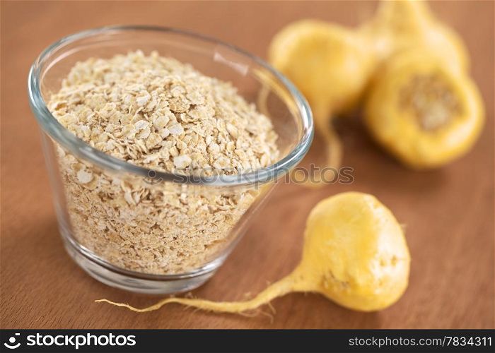 Oatmeal mixed with maca or Peruvian ginseng (lat. Lepidium meyenii), with fresh maca roots around (Selective Focus, Focus one third into the oatmeal). Oatmeal with Maca