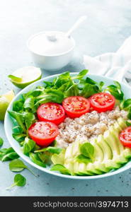 Oatmeal porridge with avocado and vegetable salad of fresh tomatoes and lettuce. Healthy dietary breakfast