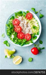 Oatmeal porridge with avocado and vegetable salad of fresh tomatoes and lettuce. Healthy dietary breakfast. Top view