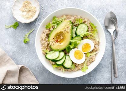 Oatmeal porridge with boiled egg, cucumber and avocado