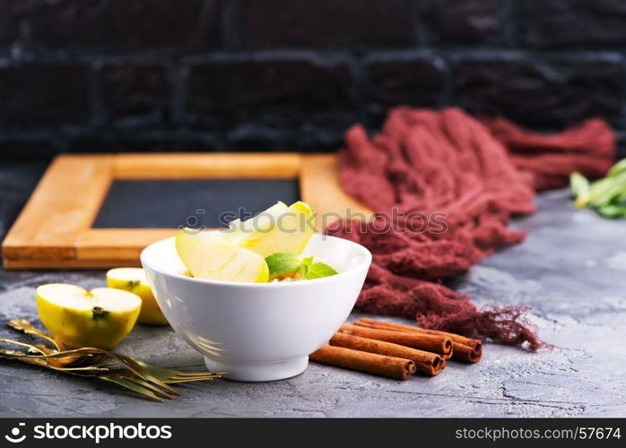 Oatmeal with fresh apples and cinnamon in the bowl