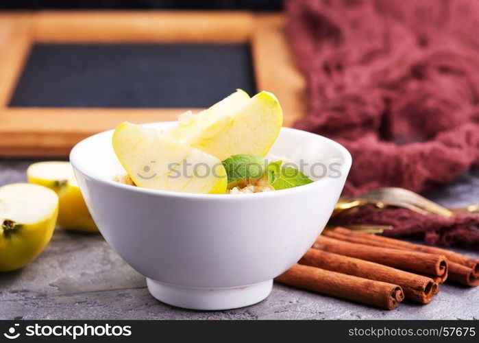 Oatmeal with fresh apples and cinnamon in the bowl