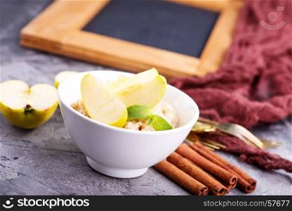 Oatmeal with fresh apples and cinnamon in the bowl
