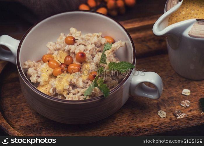 oatmeal with sea buckthorn. oatmeal with sea buckthorn butter and greens with pine nuts and sauce