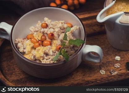 oatmeal with sea buckthorn. oatmeal with sea buckthorn butter and greens with pine nuts and sauce