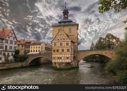 Obere bridge and Altes Rathaus and cloudy sky in Bamberg, Germany, sepia toned&#xA;