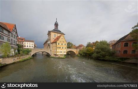 Obere bridge (brucke) and Altes Rathaus and cloudy sky in Bamberg, Germany&#xA;