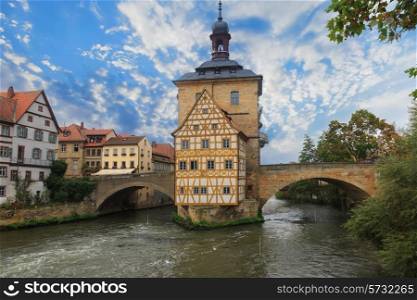 Obere bridge (brucke) and Altes Rathaus and cloudy sky in Bamberg, Germany&#xA;