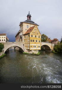 Obere bridge (brucke) and Altes Rathaus and cloudy sky in Bamberg, Germany&#xA;