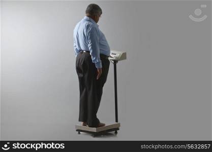 Obese man checking his weight