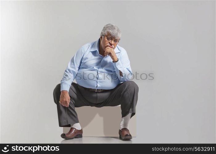 Obese old man feeling sad