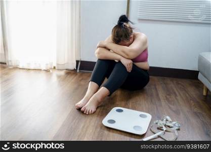 Obese Woman with fat upset bored of dieting Weight loss fail  Fat diet and scale sad asian woman on weight scale at home weight control