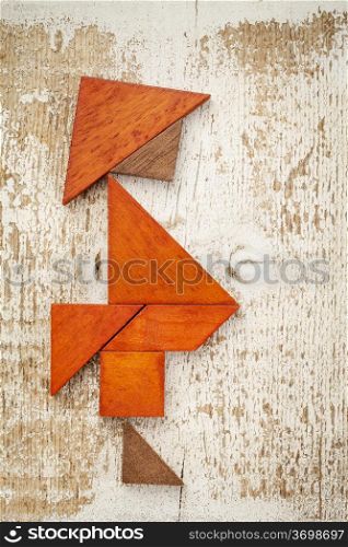 obesity concept - abstract figure of a fat man built from seven tangram wooden pieces, a traditional Chinese puzzle game,, rough white painted barn wood background