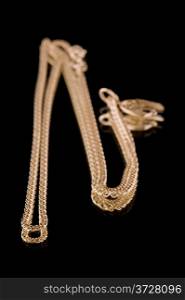 object on black - Golden chain and scorpion macro