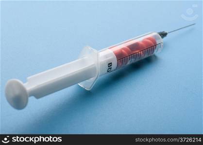 object on blue - medical Tablet and syringe