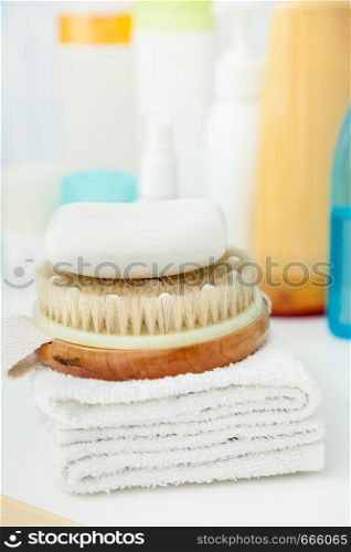 Objects for personal hygiene. Clean towel, brush and soap for cleaning. Bath, shower accessories concept.. Clean towel, brush and soap