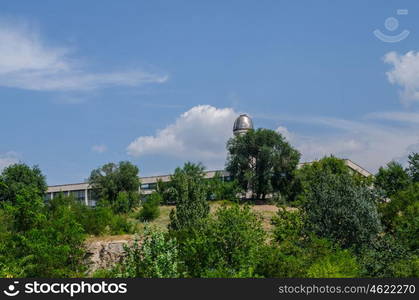 observatory on the background of blue sky with trees