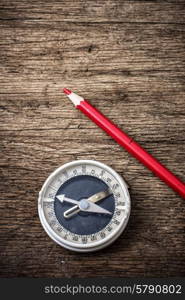 obsolete compass . obsolete compass on wooden table top in retro style